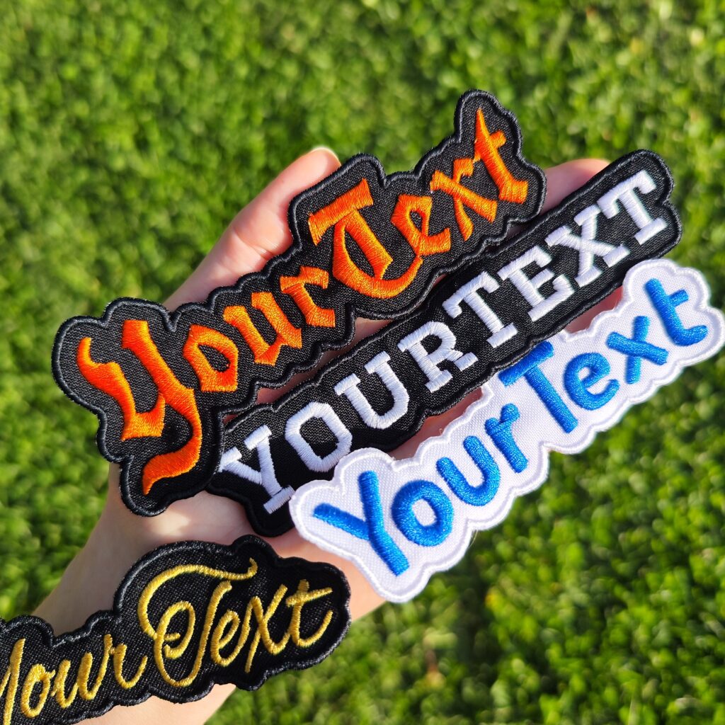 custom name patches on hand green grass background, by Mottopatch