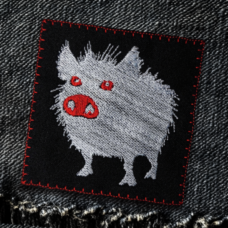 pig patch punk style patch red eyes black jeans background