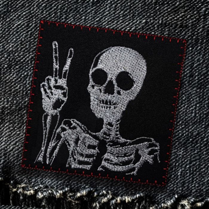 skeleton patch with hand gesture V as victory